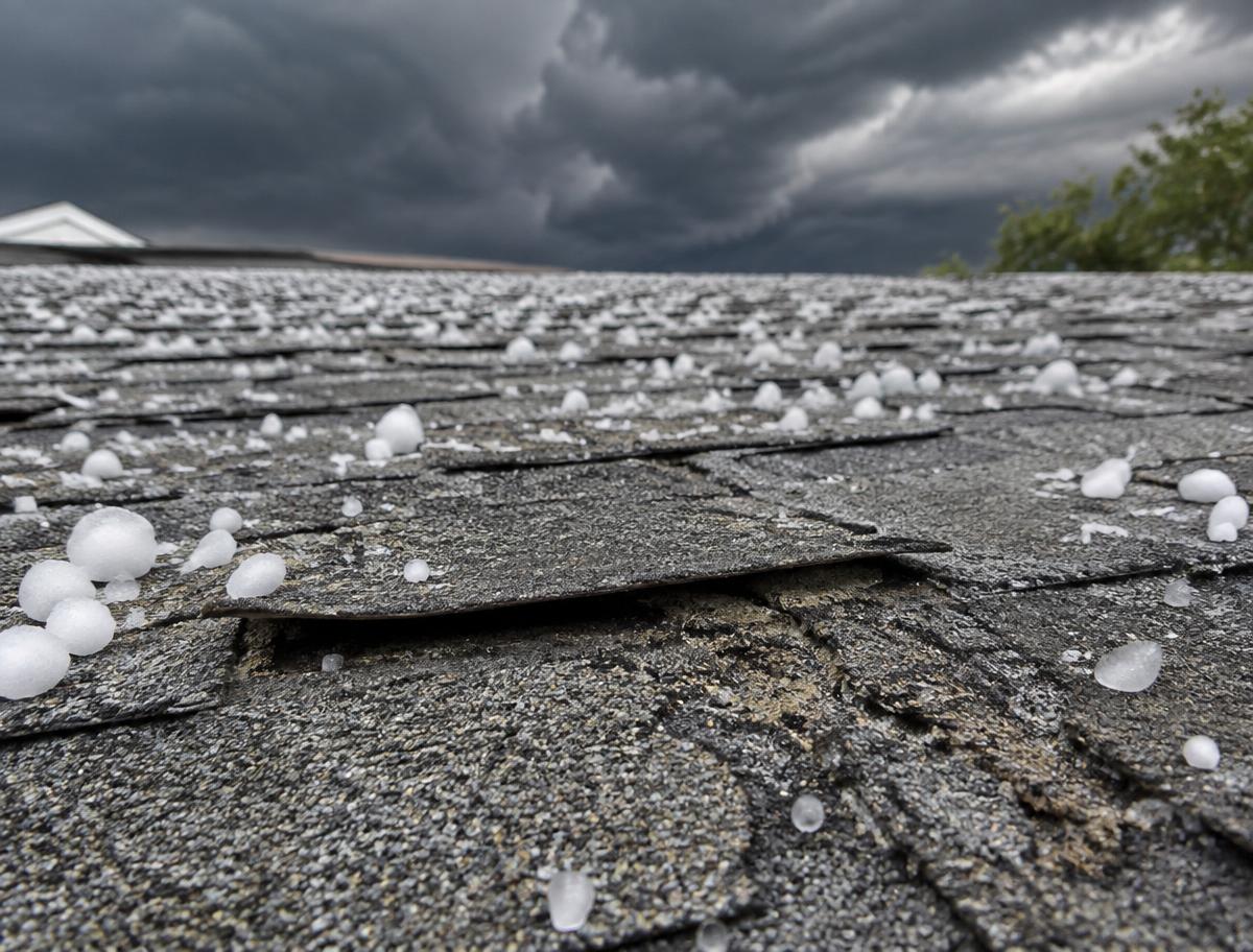 Hail damage on asphalt roof shingles after a storm (illustrative photo)